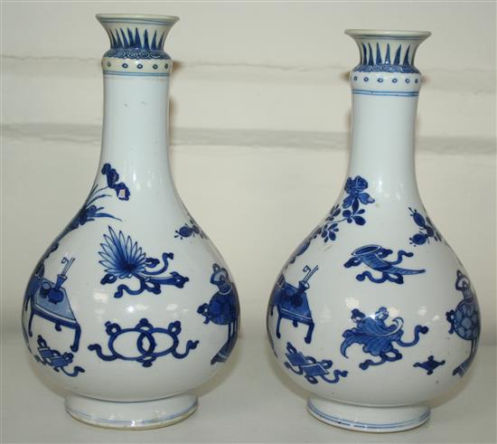 A pair of Chinese blue and white bottle vases, Kangxi period, 19.5cm, rims restored